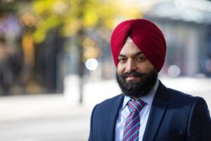 A smiling personal injury solicitor, pictured outside on a sunny day