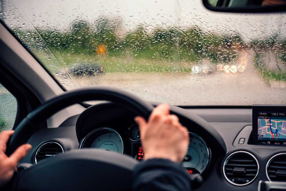 An image of a woman driving in heavy rain